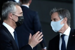 U.S. Secretary of State Antony Blinken, right, and NATO Secretary General Jens Stoltenberg wear protective masks during a meeting of NATO foreign ministers at NATO headquarters in Brussels, March 23, 2021.