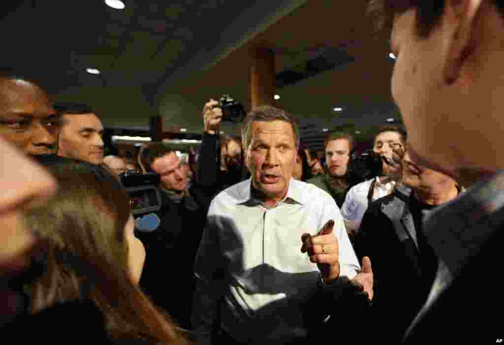Republican presidential candidate, Ohio Governor John Kasich, talks to voters during a campaign stop at a high school Feb. 7, 2016, in Concord, New Hampshire.