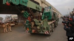 An Indian army truck carrying military equipment moves towards the Indian air force base in Pathankot, India, Monday, Jan. 4, 2016.