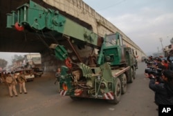 An Indian army truck carrying military equipment moves towards the Indian air force base in Pathankot, India, Jan. 4, 2016.