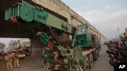 An Indian army truck carrying military equipment moves towards the Indian air force base in Pathankot, India, Monday, Jan. 4, 2016.