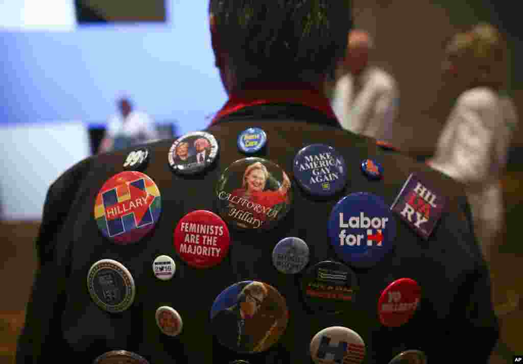 Larry Coffey poses with his pins supporting Democratic presidential candidate Hillary Clinton during an election watch party in Las Vegas, Nov. 8, 2016.