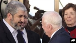 Hamas leader Khaled Mashaal, left, shakes hands with former U.S. President Jimmy Carter as former Irish President Mari Robinson, right, looks on in Damascus, Syria, Tuesday, Oct. 19, 2010
