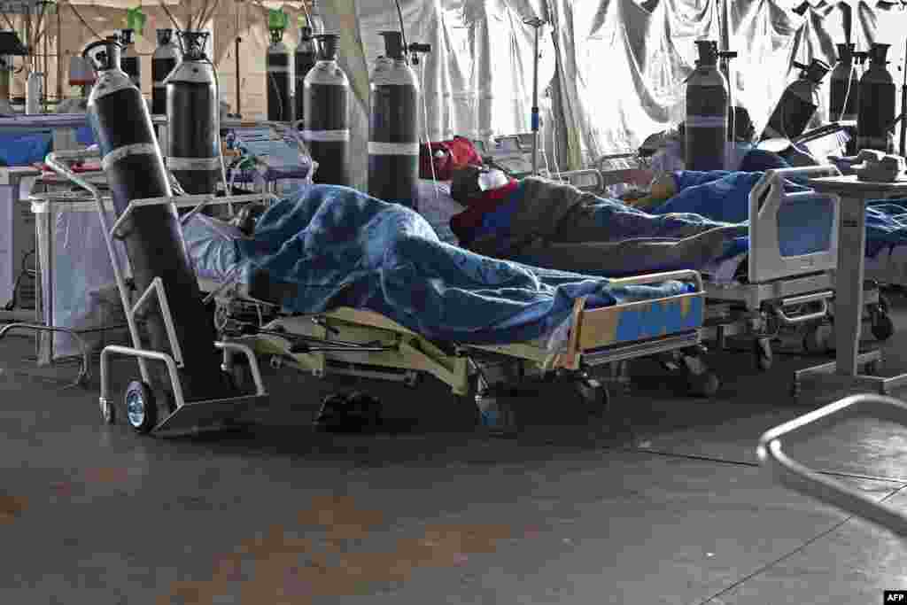 Patients are seen lying on hospital beds inside a temporary ward for possible COVID-19 coronavirus patients at Steve Biko Academic Hospital in Pretoria, South Africa.