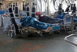 Patients are seen lying on hospital beds inside a temporary ward for possible COVID-19 coronavirus patients at Steve Biko Academic Hospital in Pretoria, South Africa, Jan. 11, 2021.
