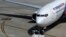 A Malaysia Airlines plane sits on the tarmac at Kuala Lumpur International Airport in Sepang, July 19, 2014. 