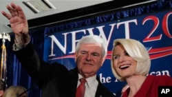 Republican presidential candidate and former House Speaker Newt Gingrich waves to the crowd with his wife Callista during a rally, Saturday, Jan. 21, 2012, in Columbia, South Carolina