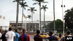 People look at the damaged building of Cameroon's parliament on November 17, 2017 in Yaounde, after a fire swept through the main building overnight, causing substantial damage.