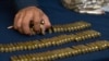 (FILES) A policeman takes bullets at the end of a presentation of members of the drug cartel "La Familia Michoacana" at the police command centre in Mexico City on June 17, 2009.