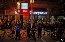 Police gather as demonstrators march in response to a not guilty verdict in the trial of former St. Louis police officer Jason Stockley, Sept. 17, 2017, in St. Louis.