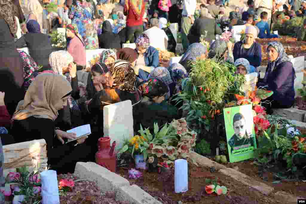 Displaced Afrin people visit the graves of their beloved ones in the eid