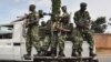 FILE - Burundi's security guards patrol near a polling station for the referendum on a controversial constitutional reform in Bujumbra, Burundi, May 17, 2018. 