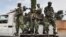 FILE - Burundi's security guards patrol near a polling station for the referendum on a controversial constitutional reform in Bujumbra, Burundi, May 17, 2018. 