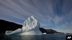 FILE - An iceberg floats in the sea near Qeqertarsuaq, Disko Island, Greenland, July 21, 2011. Levels of plastic found east of Greenland and in the Barents Sea off Norway and Russia were far higher than expected for the sparsely populated regions, according to a new report.