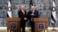 Israeli President Reuven Rivlin gives Israeli Prime Minister Benjamin Netanyahu a file during a nomination ceremony at the President's residence in Jerusalem, Sept. 25, 2019. 