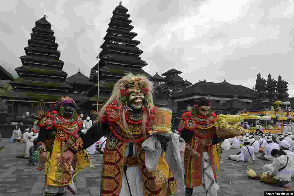 Artists perform Sidakarya mask dancing during mass prayers, expressing gratitude for the handling of the new coronavirus and seeking blessings for the start of a &quot;new normal&quot;, at Besakih temple in Karangasem, Bali, Indonesia.