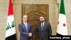 Wezîrê Dadê yê Sûrîyê Mezher el Weys ligel Serokê Civata Dadwerî ya Bilind li Îraqê, Fayiq Zeydan, li Şamê.