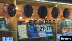 Books and a cardboard cutout representation of the moon eclipsing the sun on August 21, 2017 are seen at a bookstore in Jackson, Wyoming, U.S. July 12, 2017.