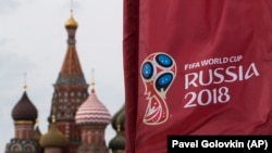 A flag with the logo of the World Cup 2018 on display with the St. Basil's Cathedral in the background, in Moscow, Russia, Monday, June 4, 2018.