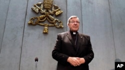 FILE - Cardinal George Pell arrives to make a statement, at the Vatican, June 29, 2017. 