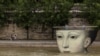 People hang out by the River Seine near an art installation for the Olympics, in Paris, France, August 3, 2024. 