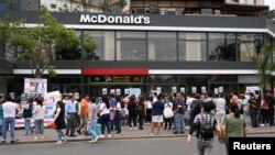 Familiares de las víctimas y ciudadanos peruanos protestan frente a un McDonalds por la muerte de dos jóvenes que fueron electrocutados por una máquina defectuosa de gaseosas. Reuters/Guadalupe Pardo.