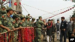 Maoist combatants greet Nepal's Prime Minister Madhav Kumar Nepal at the Shaktikhor Maoist cantonment in Chitwan, about 80 kilometers (50 miles) southwest of Katmandu, 22 Jan 2011