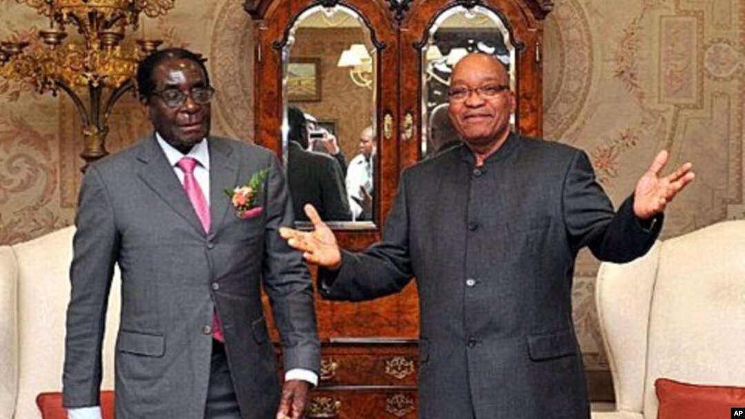 South African President Jacob Zuma (R) poses with Zimbabwe President Robert Mugabe before talks, in Pretoria, June 10, 2011
