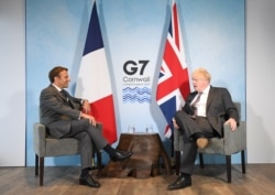 FILE - Britain's Prime Minister Boris Johnson and France's President Emmanuel Macron attend a bilateral meeting during G-7 summit in Carbis Bay, Cornwall, Britain, June 12, 2021. (Stefan Rousseau/Pool via Reuters)