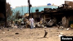 FILE: A man walks near damaged buildings at the central market during clashes between the paramilitary Rapid Support Forces and the army in Khartoum North, Sudan April 27, 2023