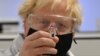 Britain's Prime Minister Boris Johnson poses for a photograph with a vial of the AstraZeneca/Oxford University COVID-19 candidate vaccine at Wockhardt's pharmaceutical manufacturing facility in Wrexham, north Wales, on Nov. 30, 2020.