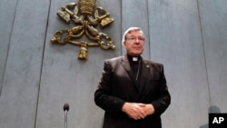 FILE - Cardinal George Pell arrives to make a statement, at the Vatican, June 29, 2017. 