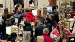 Macy's aisles are crowded with shoppers on Black Friday - called that because the surge of shoppers could take retailers into profitability, Manhattan, 26 Nov. 2010