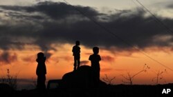 Kurdish children play on a road in Yemisli, Hakkari province near the Iraqi border in southeastern Turkey, October 22, 2011.