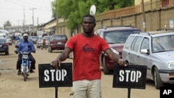 Security in front of the Good News Church in Kaduna, Nigeria, May 3, 2012.