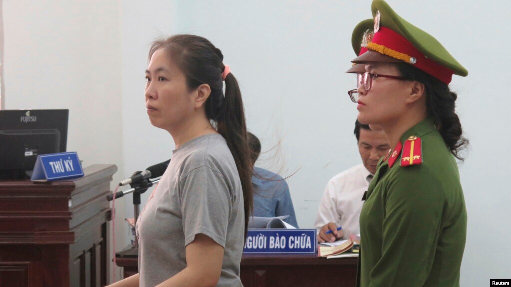 Prominent blogger Nguyen Ngoc Nhu Quynh, left, stands trial in the south central province of Khanh Hoa, Vietnam, June 29, 2017. She was accused of distorting government policies and defaming the Communist regime on her Facebook posts.