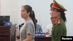 Prominent blogger Nguyen Ngoc Nhu Quynh, left, stands trial in the south central province of Khanh Hoa, Vietnam, June 29, 2017. She was accused of distorting government policies and defaming the Communist regime on her Facebook posts.