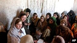 Susan Retik Ger and Patti Quigley visit a literacy class in Afghanistan.