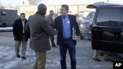 FILE - In this Feb. 20, 2015, file photo, U.S. Secretary of Defense Ash Carter, center, is greeted by Senior Military Assistant U.S. Army Maj. Gen. Ron Lewis as they arrive at Andrews Air Force Base, Md., to travel to Afghanistan. 