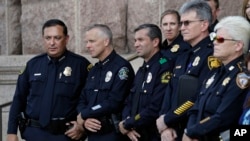 Austin Police Chief Brian Manley, second from left, and other Texas police officers take part in a public safety event where they spoke against a proposed "bathroom bill," July 25, 2017, in Austin, Texas. 