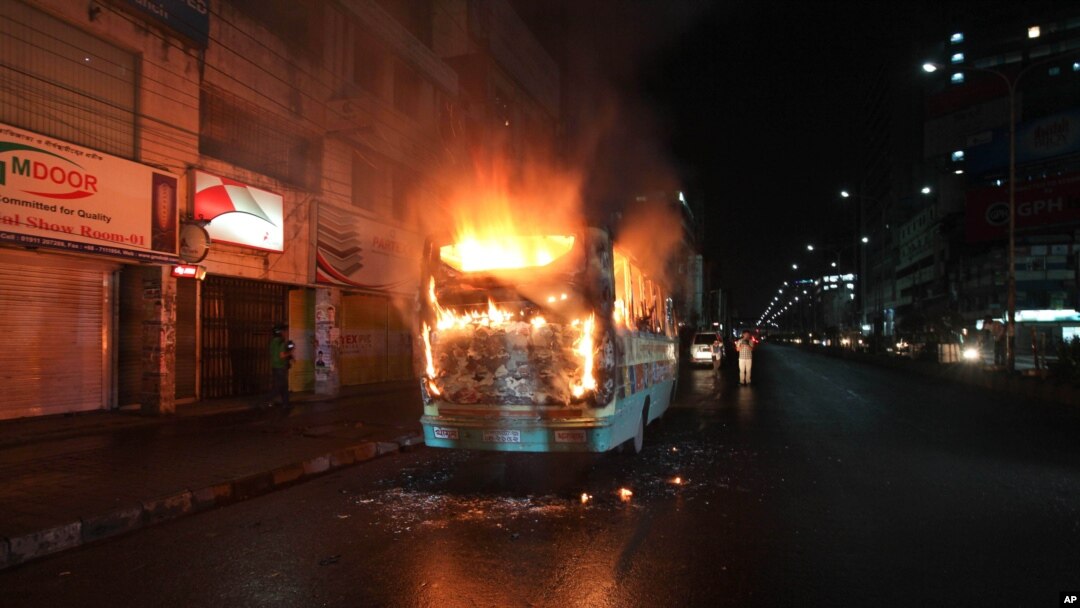 FILE - A bus stands in flames after it was set afire by opposition supporters trying to defy a ban on protests, in Dhaka, Bangladesh, Oct. 25, 2013.