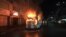 FILE - A bus stands in flames after it was set afire by opposition supporters trying to defy a ban on protests, in Dhaka, Bangladesh, Oct. 25, 2013.