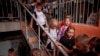 FILE - Children from Gymnasium No. 6 head to a basement set up with classrooms during an air alert in Zaporizhzhia, Ukraine, Sept. 3, 2024. 