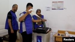 Officials work at a polling station during parliamentary elections in the Kurdistan region of Iraq, in Irbil, Oct. 20, 2024.