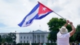 People participate in a rally outside the White House in Washington, Tuesday, July 13, 2021, in support of the protesters in Cuba. The problems of two tiny Caribbean states, Cuba and Haiti, have vexed U.S. presidents for decades. Now, Haiti and Cuba…