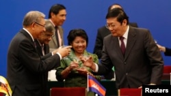 Chinese Finance Minister Lou Jiwei, right, toasts with guests at the signing ceremony of the Asian Infrastructure Investment Bank in Beijing, Oct. 24, 2014. 