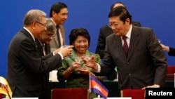 FILE - Chinese Finance Minister Lou Jiwei, right, toasts with guests at the signing ceremony of the Asian Infrastructure Investment Bank in Beijing, Oct. 24, 2014. 