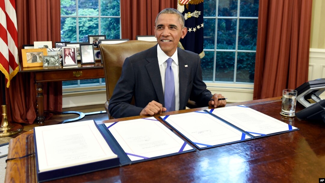 FILE - President Barack Obama smiles as he waits for the press to arrive before signing the FOIA Improvement Act of 2016 in the Oval Office of the White House in Washington, June 30, 2016.