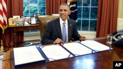 FILE - President Barack Obama smiles as he waits for the press to arrive before signing the FOIA Improvement Act of 2016 in the Oval Office of the White House in Washington, June 30, 2016.