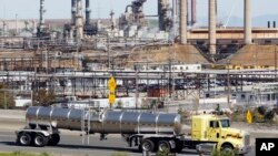 FILE - In this March 9, 2010 file photo, a tanker truck passes the Chevron oil refinery in Richmond, Calif. 